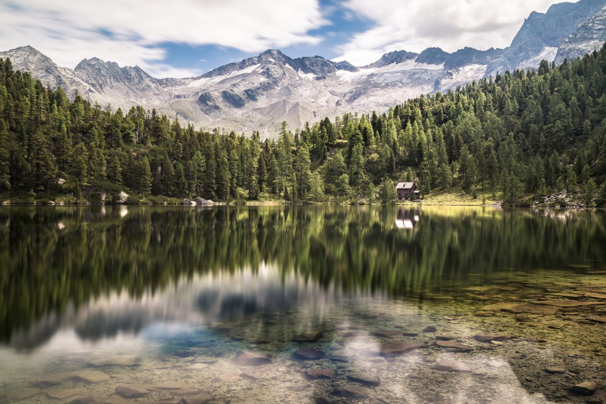 Der Reedsee, Smaragdgrünes Naturjuwel im Gasteinertal mit Bergen im Hintergrund.